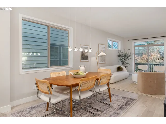 a dining room with furniture and large windows