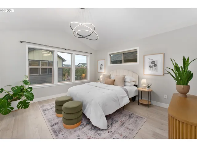 a bedroom with a large bed and a potted plant