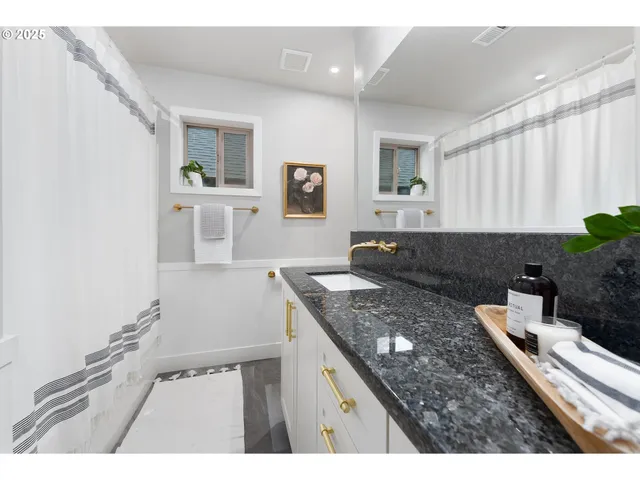 a living room with granite countertop furniture and a wooden floor