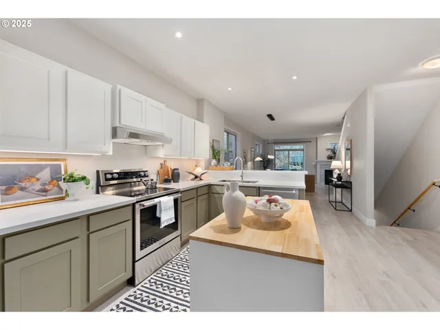 a kitchen with a sink stove and cabinets