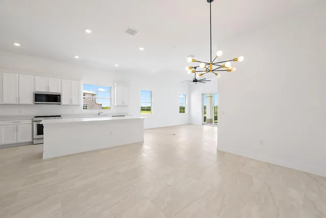 a view of a livingroom with a ceiling fan and window