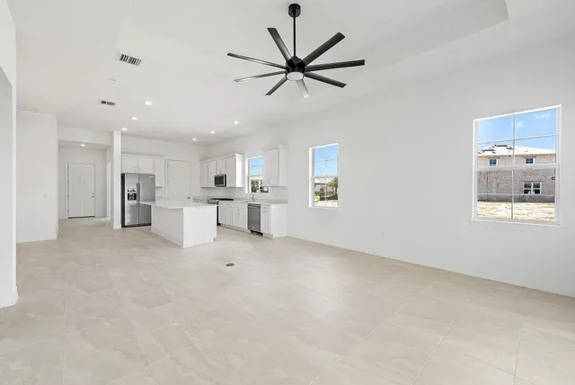 a view of room with window and ceiling fan