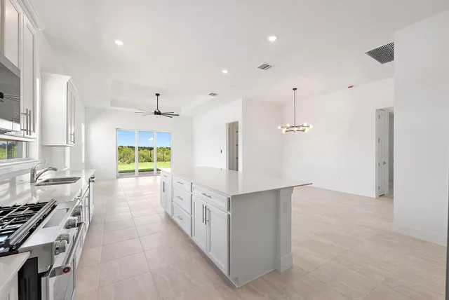 a kitchen with stainless steel appliances granite countertop a sink and a refrigerator