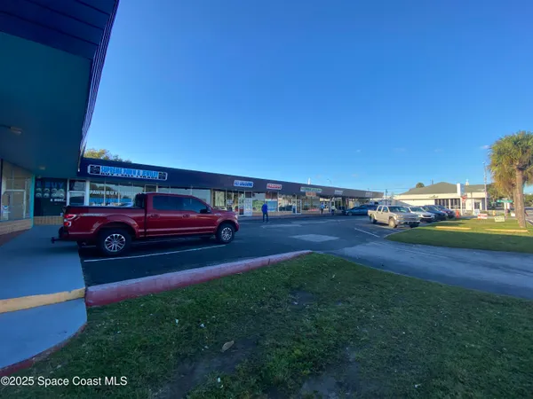 a view of a street with a building in the background
