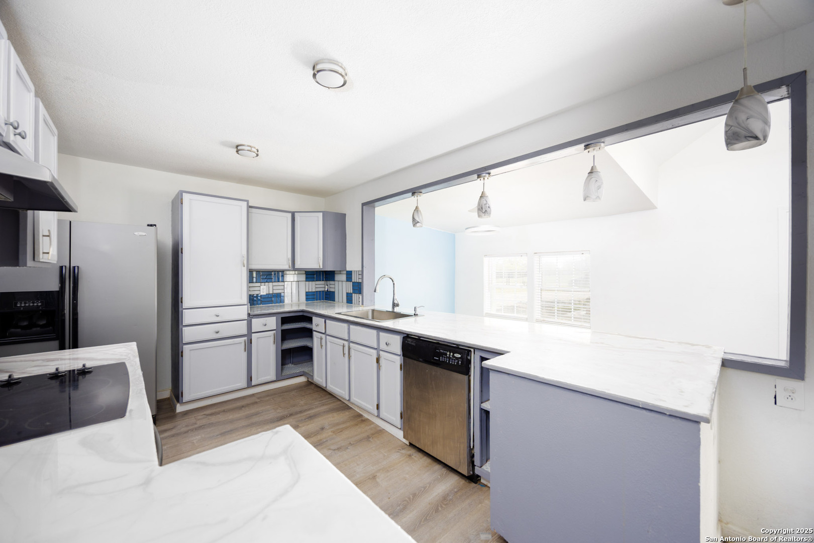 641 Weber Road Seguin, TX 78155 - Photo 11 of 27 a kitchen with a sink window and stainless steel appliances