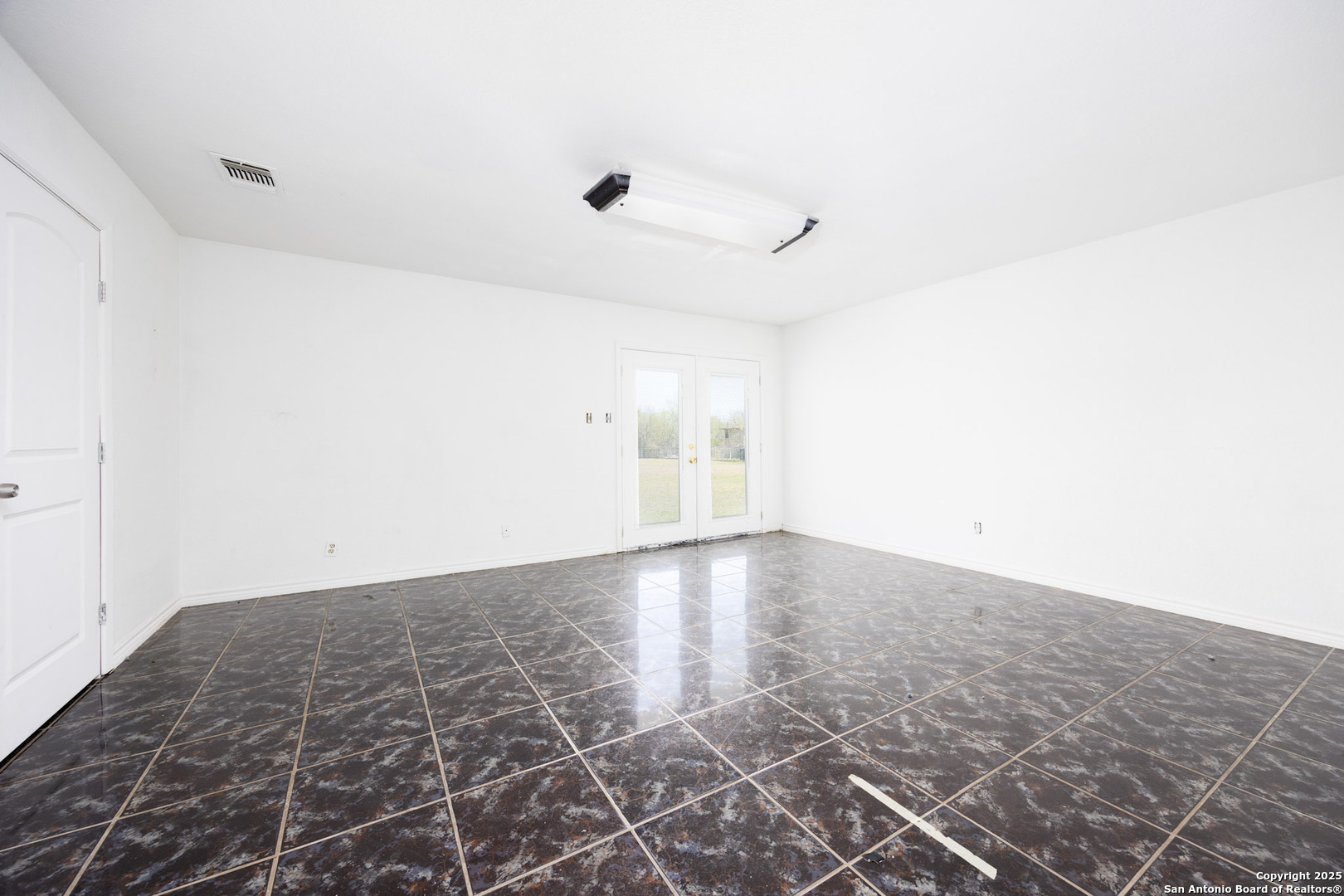 641 Weber Road Seguin, TX 78155 - Photo 14 of 27 an empty room with wooden floor and windows