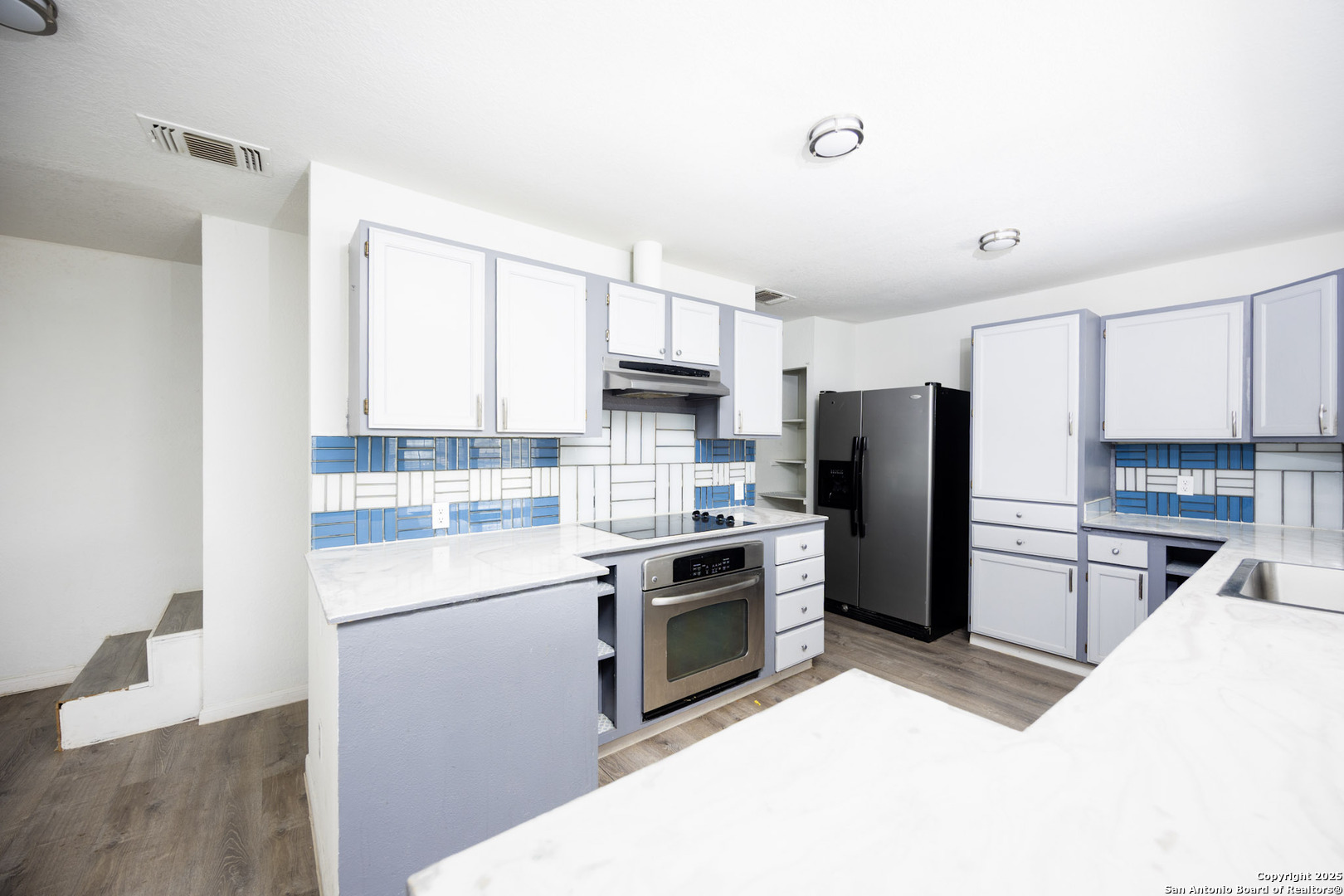 641 Weber Road Seguin, TX 78155 - Photo 10 of 27 a kitchen with refrigerator a microwave a sink and cabinets