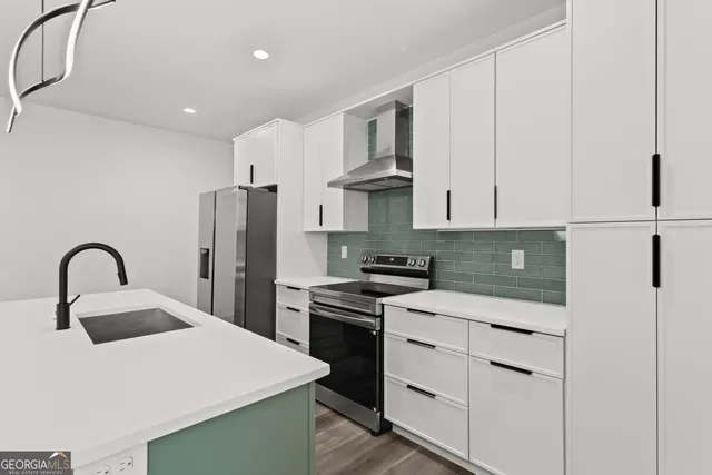 a kitchen with cabinets and stainless steel appliances