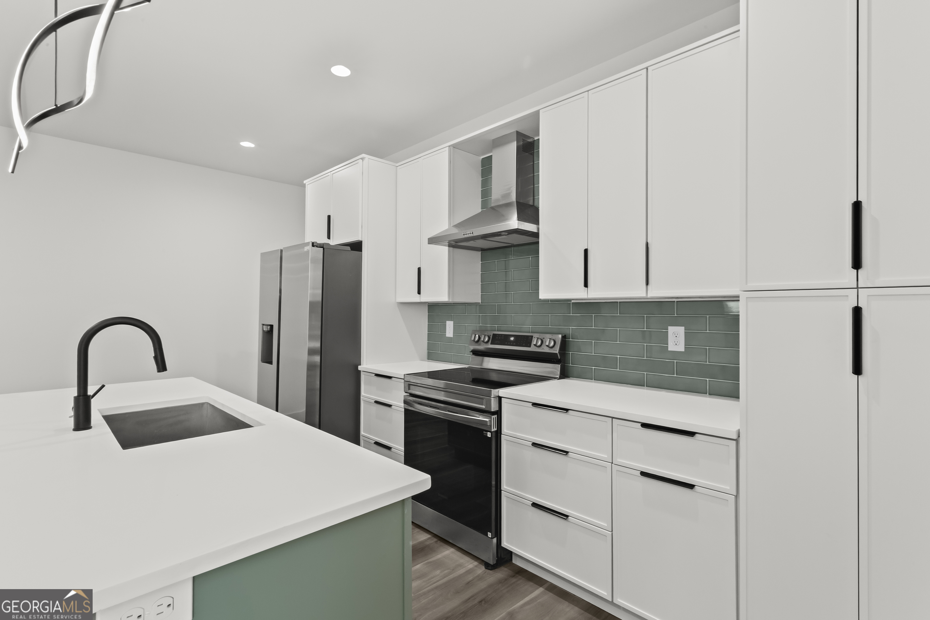 598 Formwalt Street Southwest Atlanta, GA 30312 - Photo 11 of 23 a kitchen with cabinets and stainless steel appliances