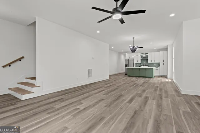 a view of kitchen and hall with wooden floor