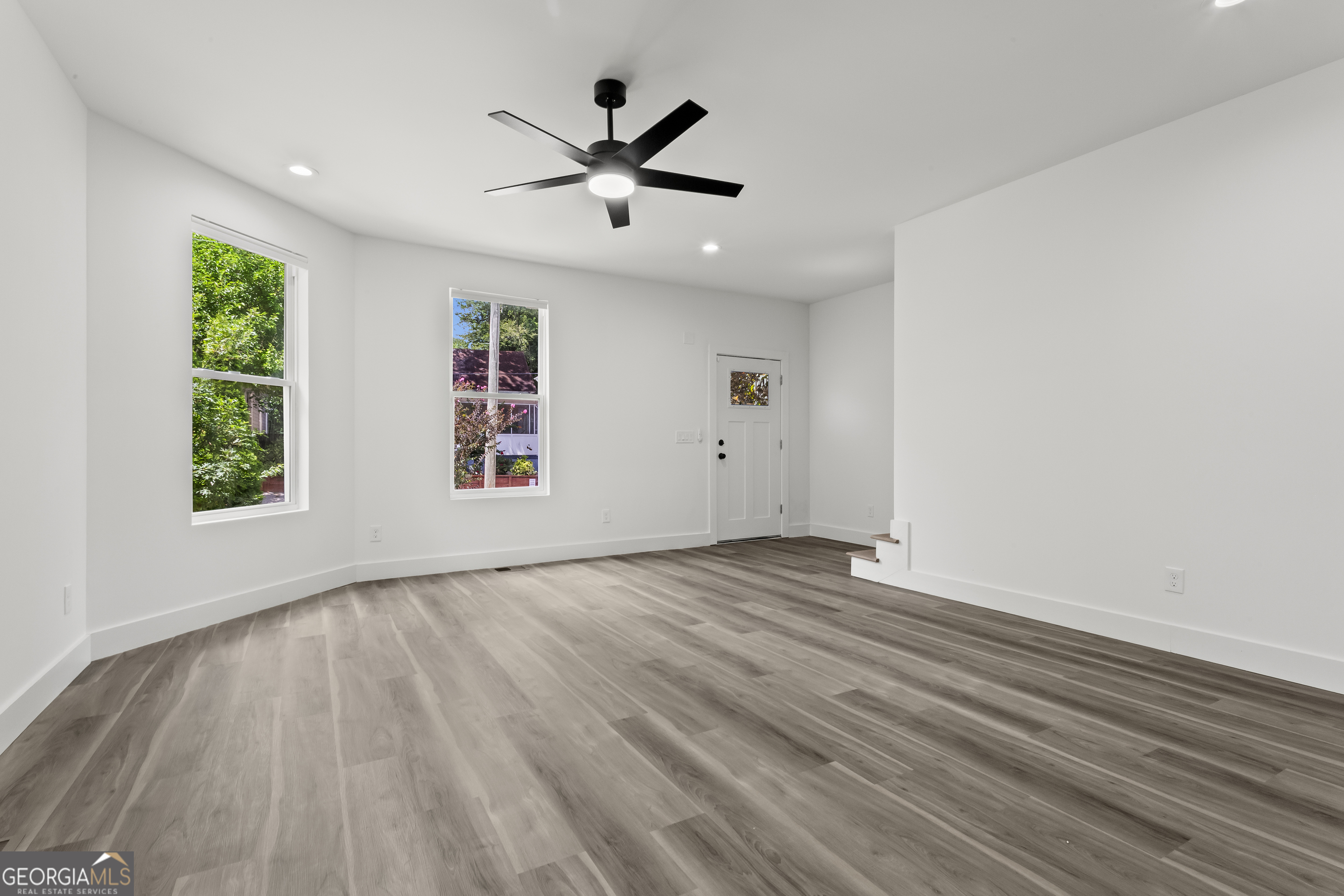 598 Formwalt Street Southwest Atlanta, GA 30312 - Photo 6 of 23 a view of empty room with wooden floor and fan