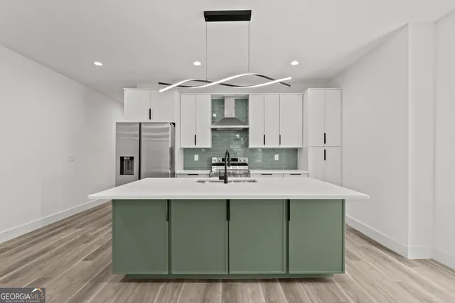 a kitchen with stainless steel appliances granite countertop a sink and a refrigerator