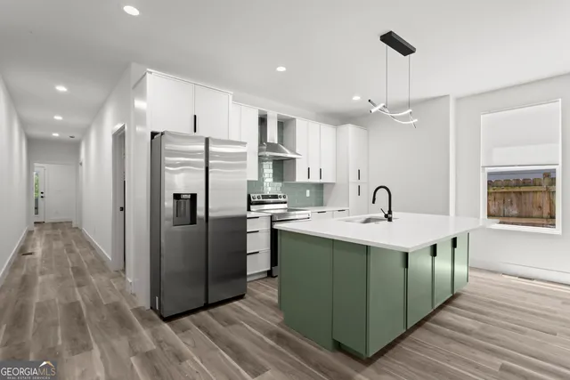 a kitchen with stainless steel appliances a sink and a refrigerator