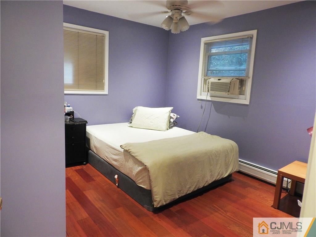 36 Fox Road Edison, NJ 08817 - Photo 14 of 21 a bedroom with a bed and a lamp on dresser
