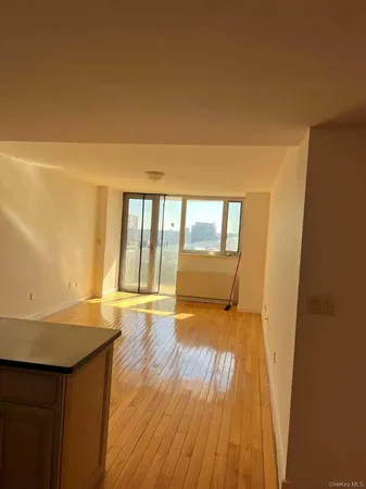 a view of an empty room and wooden floor