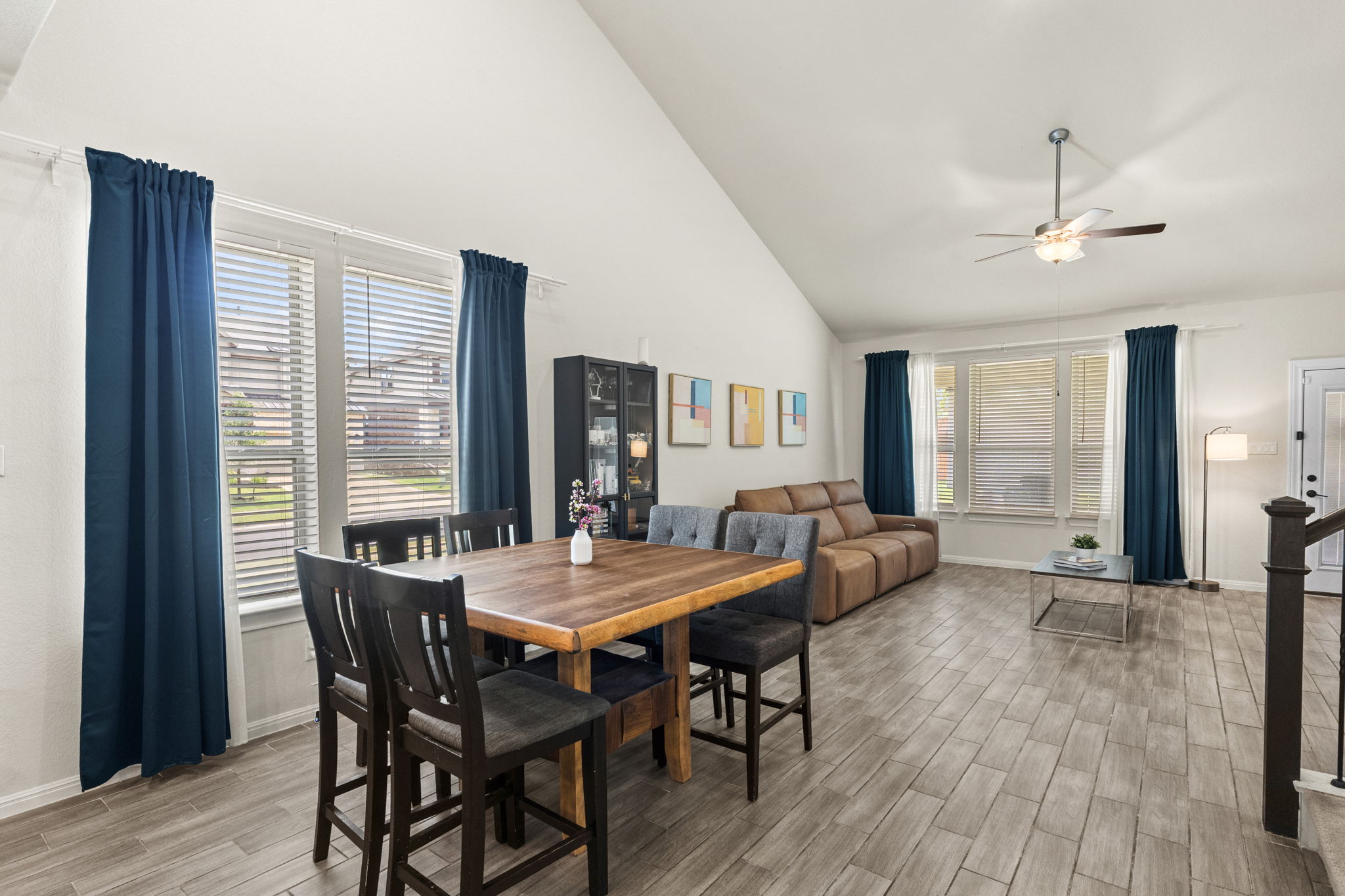548 Purple Heart Drive Buda, TX 78610 - Photo 4 of 35 The open-concept living and dining area boasts vaulted ceilings and durable plank tile flooring.