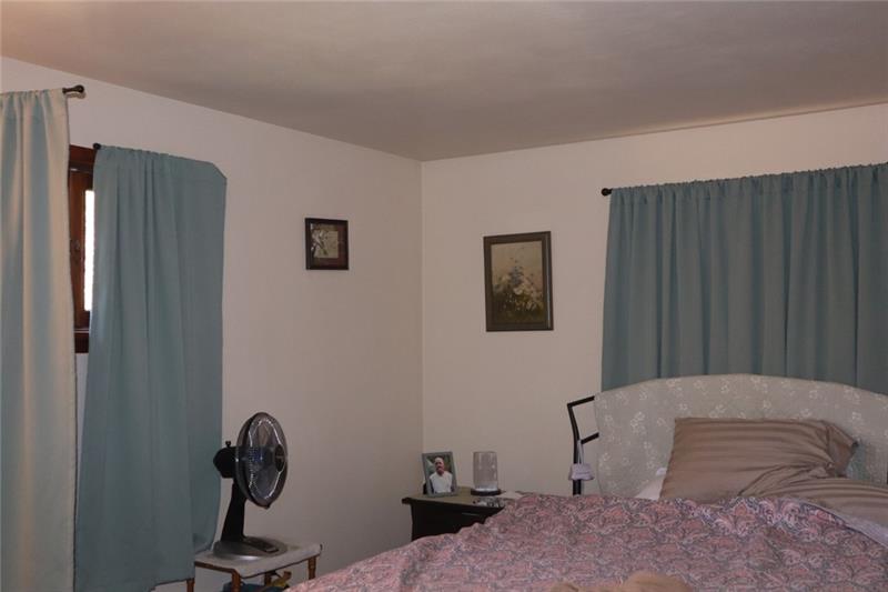 778 Katherine Street Rochester, PA 15074 - Photo 16 of 22 a bedroom with a bed and a potted plant