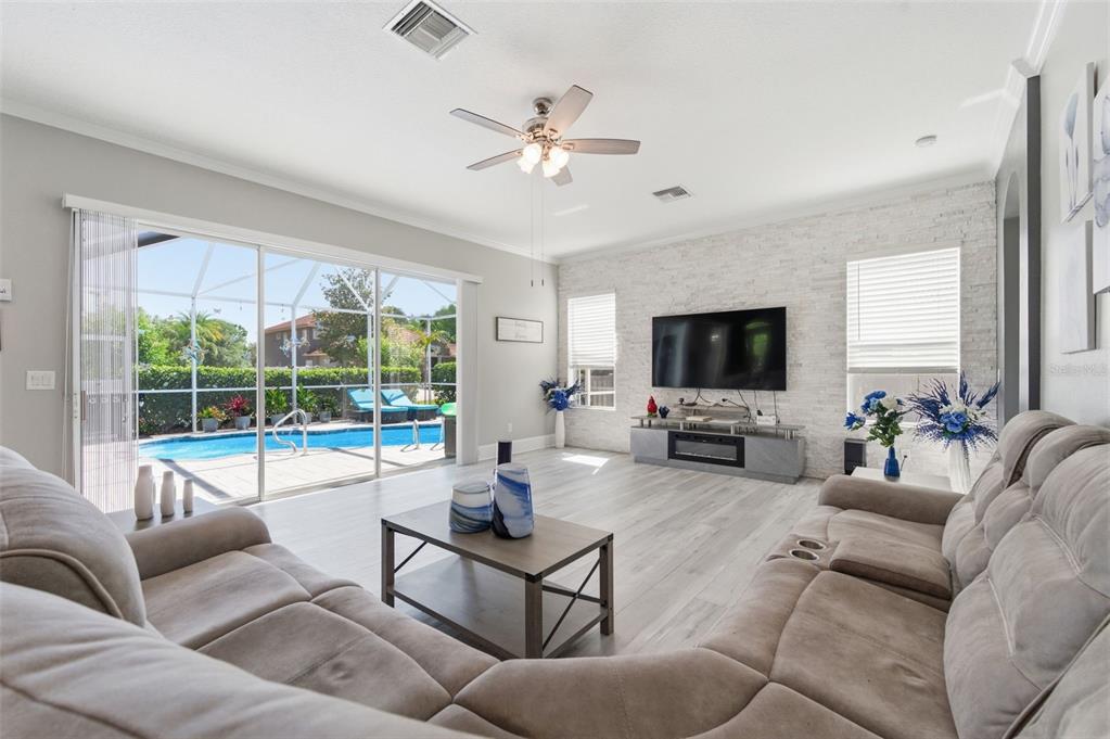 11508 Oyster Bay Circle New Port Richey, FL 34654 - Photo 30 of 98 a living room with furniture and a flat screen tv