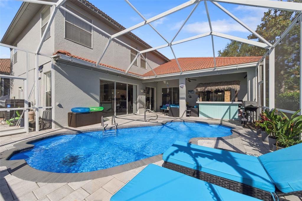 11508 Oyster Bay Circle New Port Richey, FL 34654 - Photo 3 of 98 a view of a patio with table and chairs under an umbrella