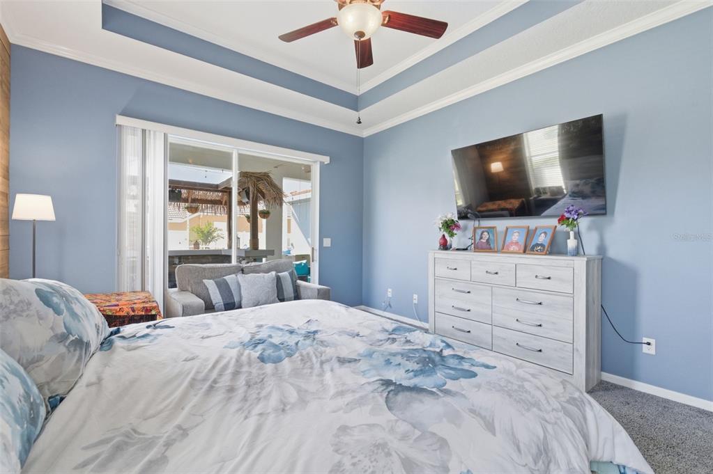 11508 Oyster Bay Circle New Port Richey, FL 34654 - Photo 37 of 98 a bedroom with a large bed and a flat tv screen on dresser