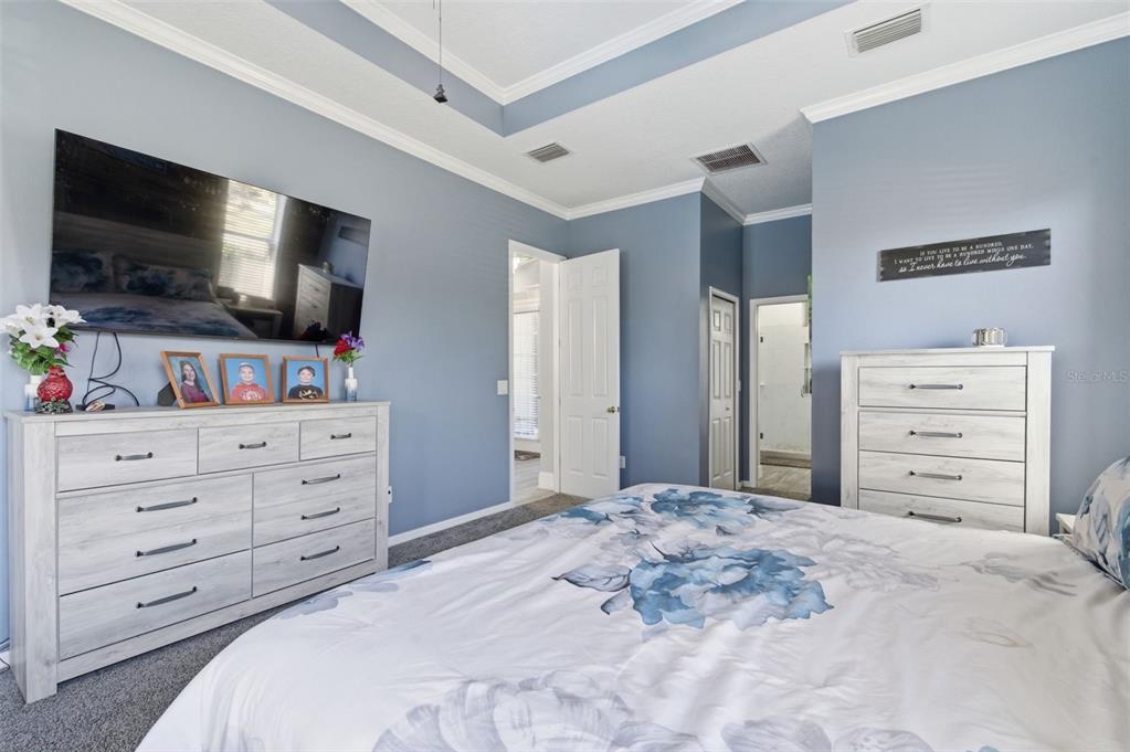 11508 Oyster Bay Circle New Port Richey, FL 34654 - Photo 38 of 98 a bedroom with a bed and a flat screen tv in it