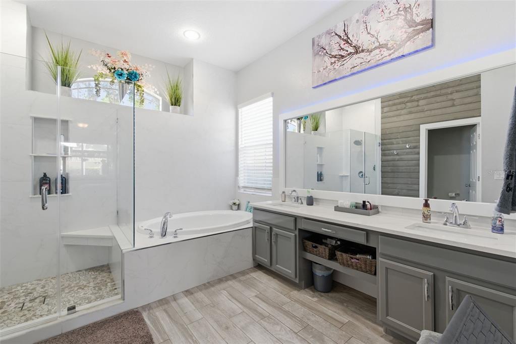 11508 Oyster Bay Circle New Port Richey, FL 34654 - Photo 39 of 98 a bathroom with a tub double vanity sink and mirror