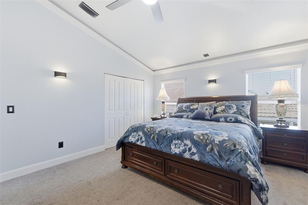 11508 Oyster Bay Circle New Port Richey, FL 34654 - Photo 53 of 98 a large bed sitting in a bedroom next to a lamp