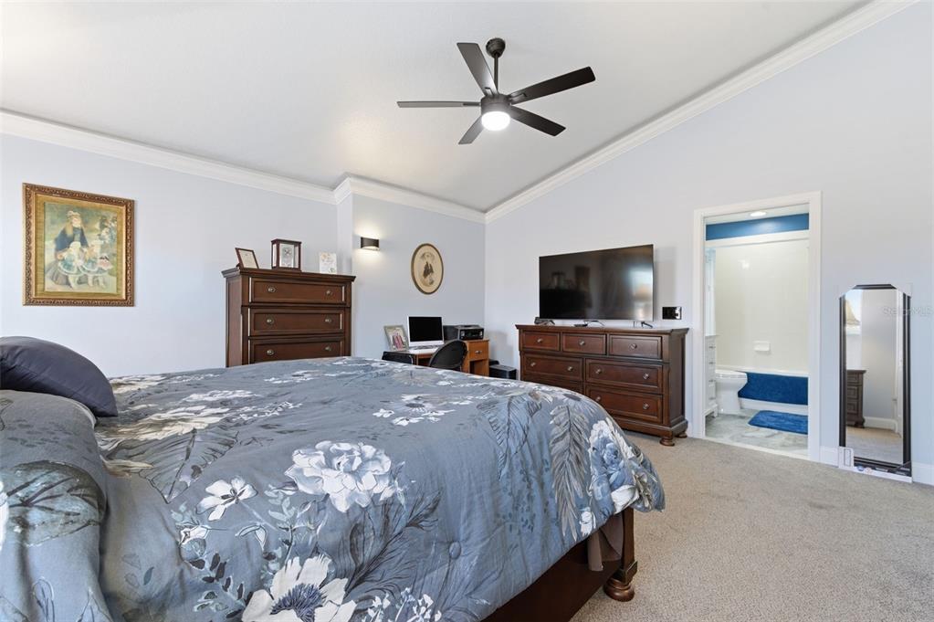 11508 Oyster Bay Circle New Port Richey, FL 34654 - Photo 55 of 98 a bedroom with a bed and a flat screen tv