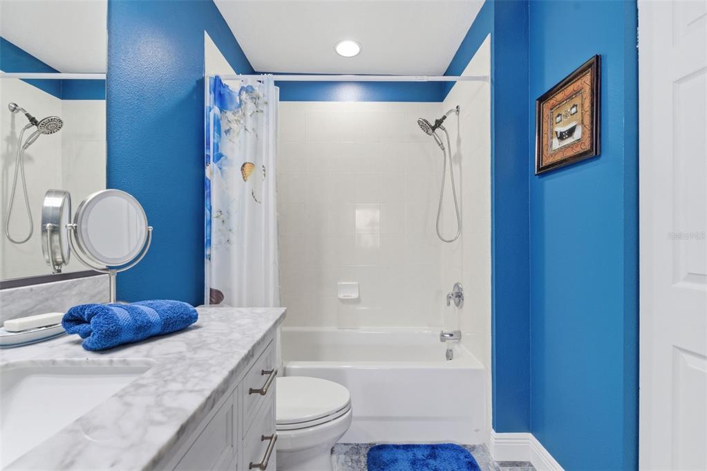 11508 Oyster Bay Circle New Port Richey, FL 34654 - Photo 57 of 98 a bathroom with a granite countertop sink toilet a shower and a mirror