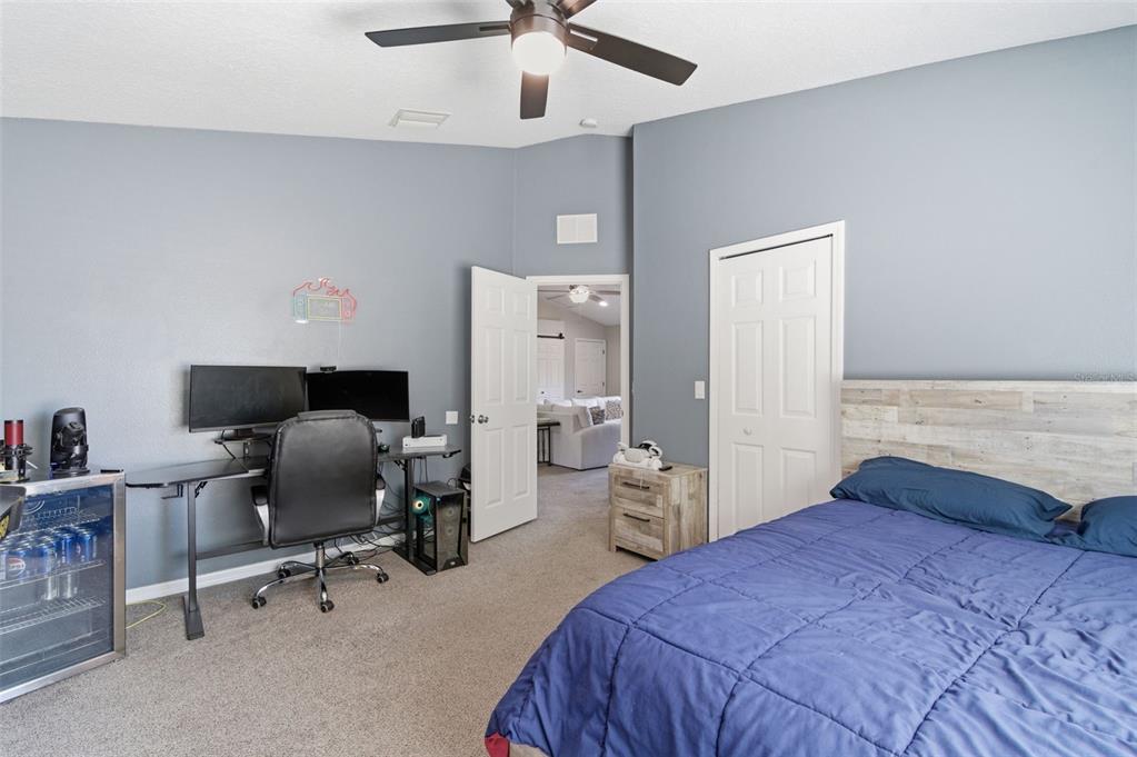 11508 Oyster Bay Circle New Port Richey, FL 34654 - Photo 63 of 98 a bedroom with a bed and a chandelier