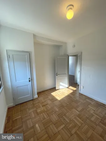 a view of a livingroom with wooden floor and a flat screen tv