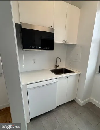 a kitchen with a microwave and cabinets