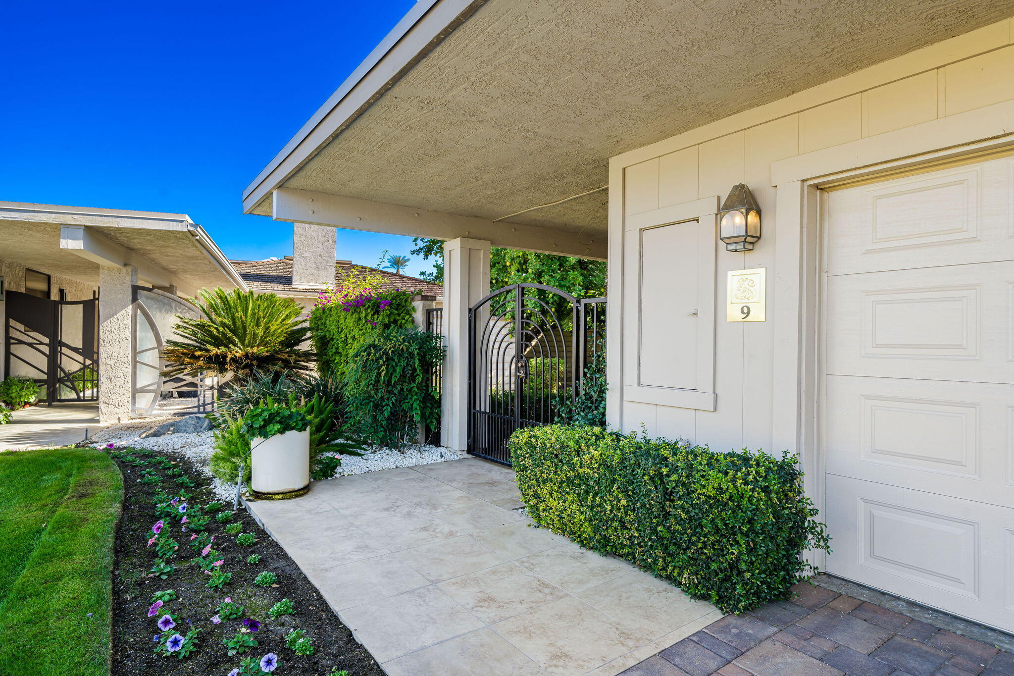 9 Rutgers Court Rancho Mirage, CA 92270 - Photo 14 of 53 a front view of a house with a yard