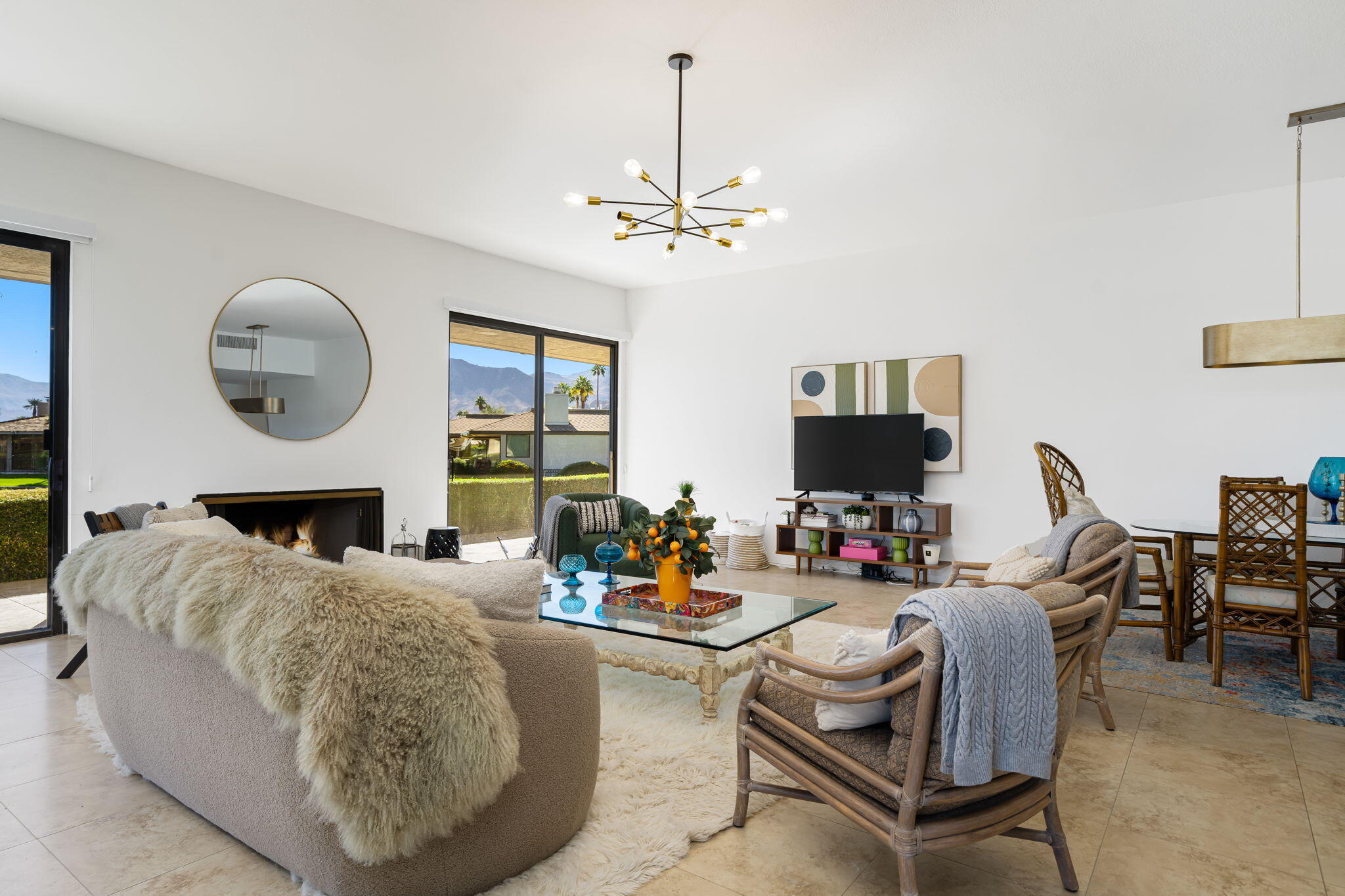 9 Rutgers Court Rancho Mirage, CA 92270 - Photo 23 of 53 a living room with furniture a fireplace and a chandelier
