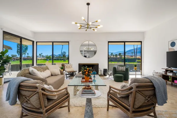 a living room with furniture and a large window