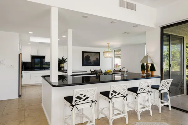 a view of a dining room with furniture and chandelier