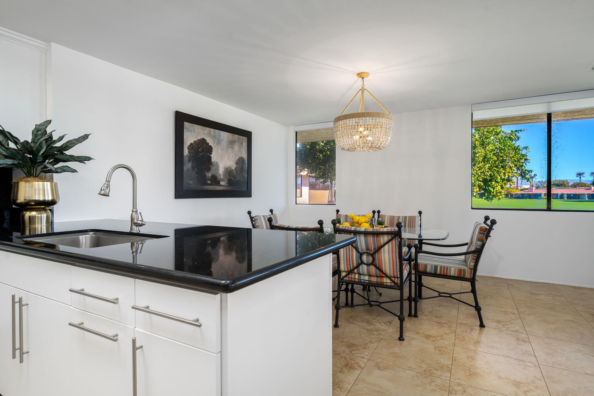9 Rutgers Court Rancho Mirage, CA 92270 - Photo 28 of 53 a kitchen with a table chairs and a window