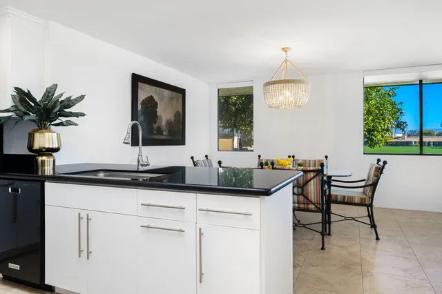 a view of a table and chairs under an umbrella