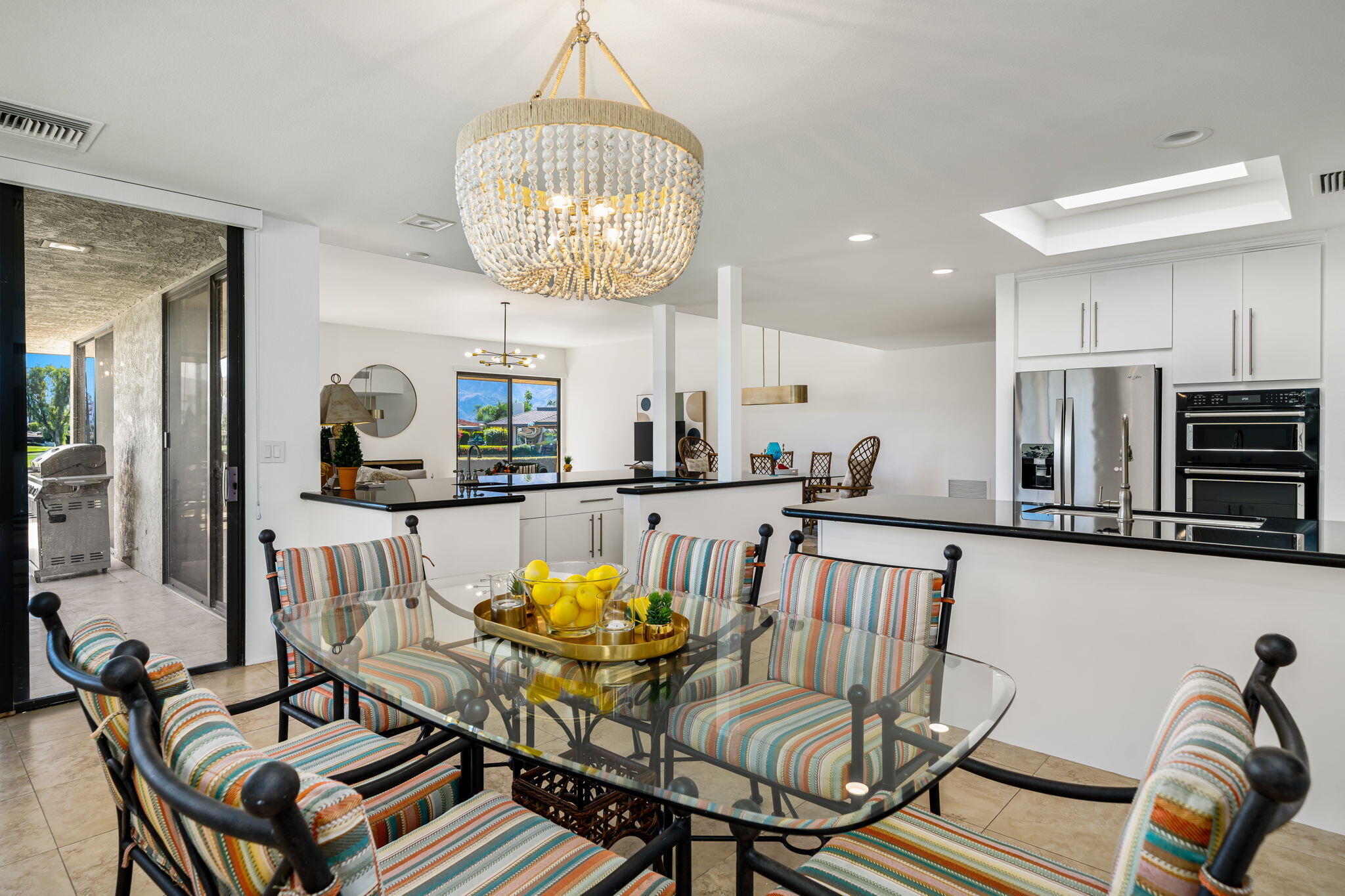 9 Rutgers Court Rancho Mirage, CA 92270 - Photo 31 of 53 a view of a dining room with furniture a chandelier and wooden floor