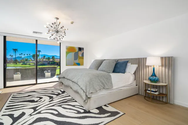 a large bathroom with a tub a sink and a large mirror