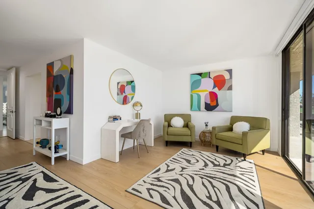 a bedroom with a bed and dresser with mirror