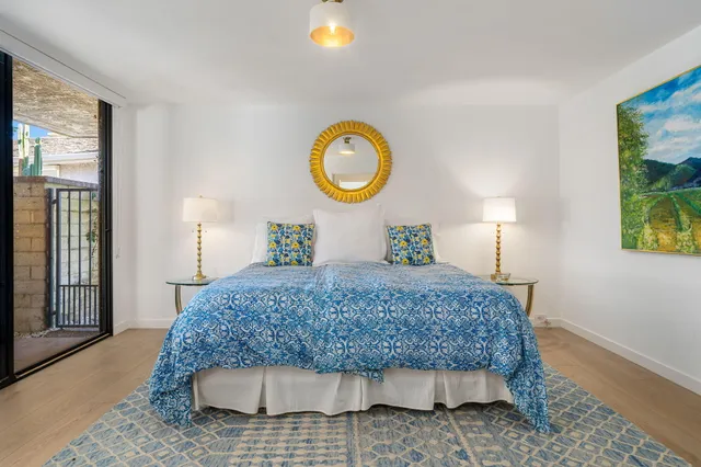 a bedroom with large bed and a large window