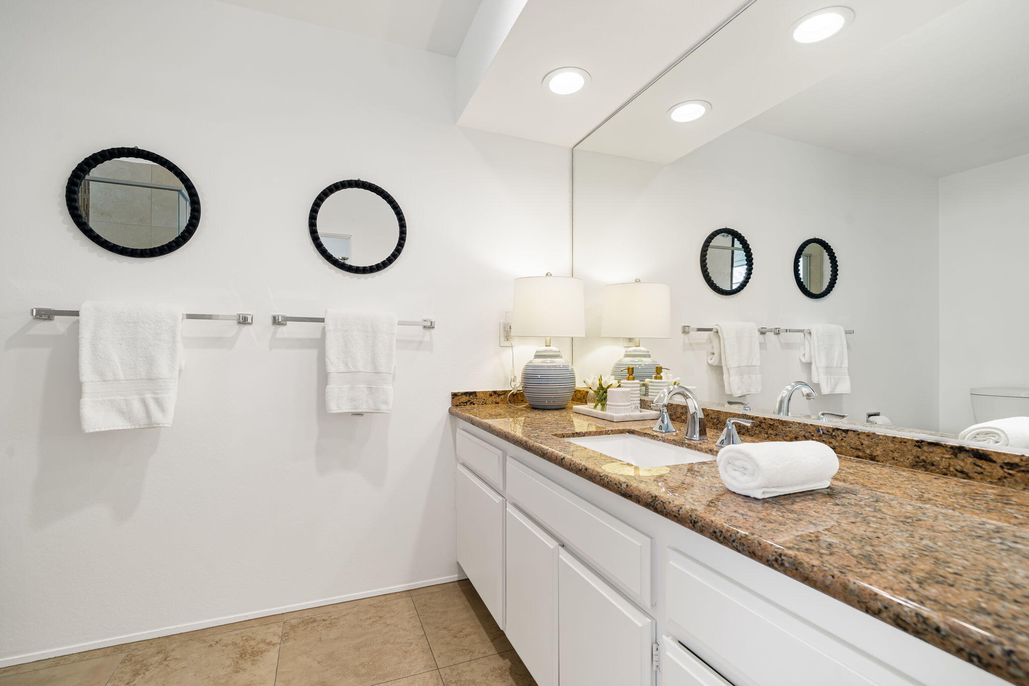 9 Rutgers Court Rancho Mirage, CA 92270 - Photo 47 of 53 a bathroom with a granite countertop sink and a mirror