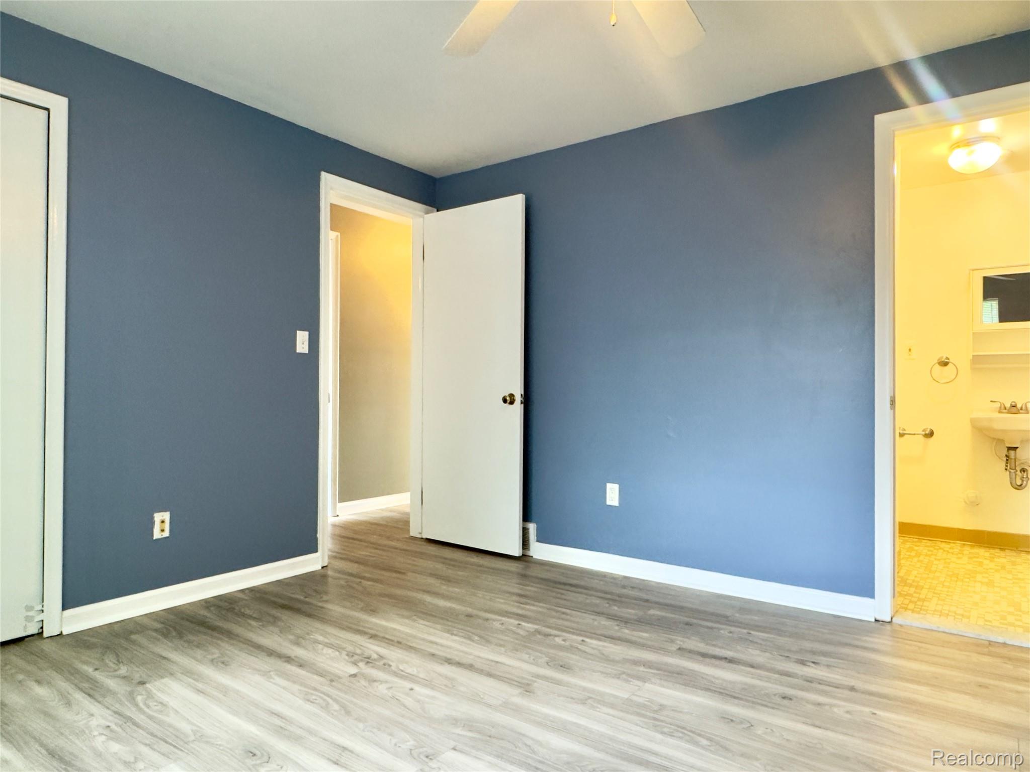 308 North Rochester Road Clawson, MI 48017 - Photo 11 of 16 Wood-finish flooring with white trim, ceiling fan, and painted walls