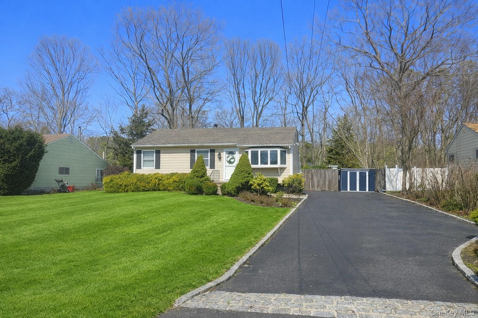 9 Fox Lane Shoreham, NY 11786 - Photo 1 of 13 a view of house in front of a big yard with large trees