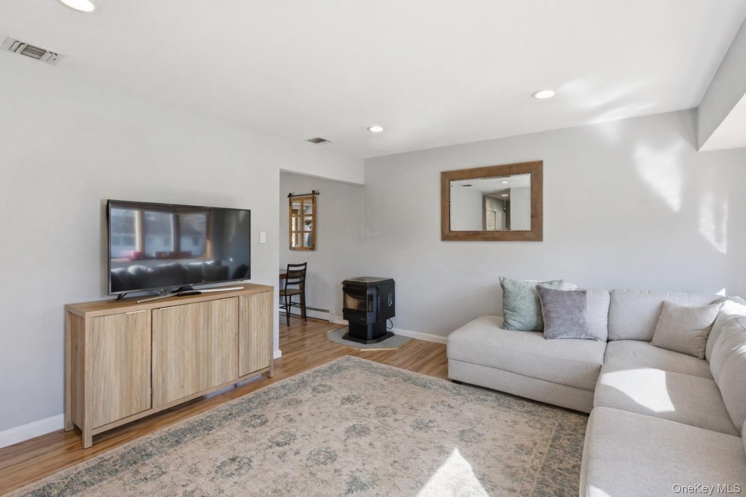 9 Fox Lane Shoreham, NY 11786 - Photo 2 of 13 a living room with furniture and a flat screen tv