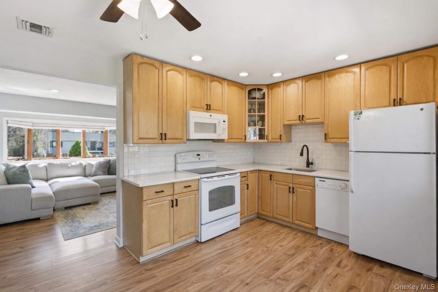9 Fox Lane Shoreham, NY 11786 - Photo 4 of 13 a kitchen with a sink cabinets stainless steel appliances and wooden floor