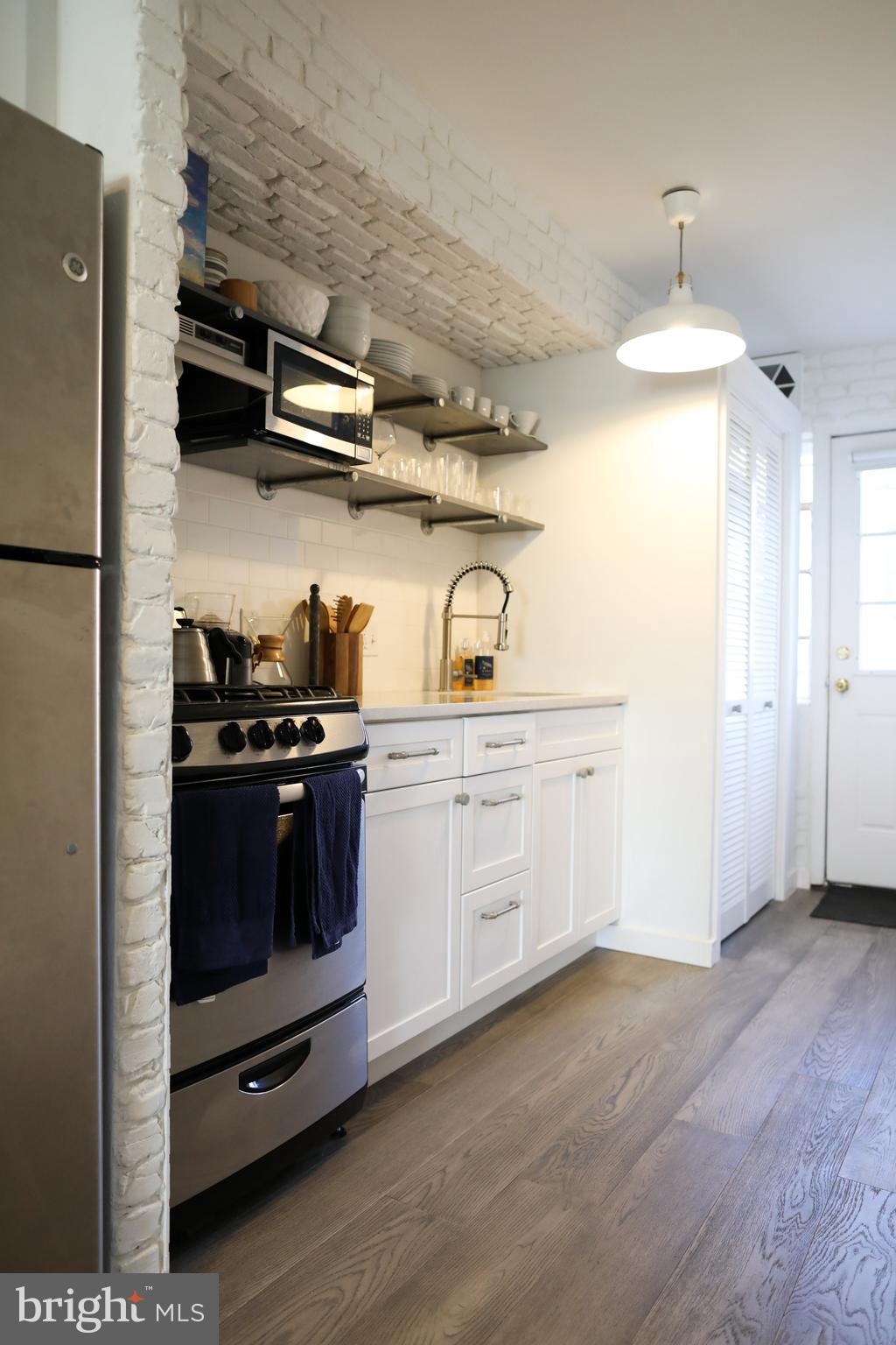1520-1524 Queen Street Northeast Washington, DC 20002 - Photo 5 of 19 a kitchen with stainless steel appliances a stove and a refrigerator