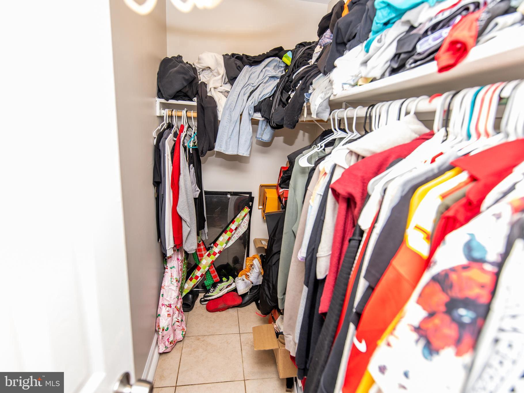 3934 Bel Pre Road, Unit 39342 Silver Spring, MD 20906 - Photo 19 of 30 a view of walk in closet with clothes and shoes