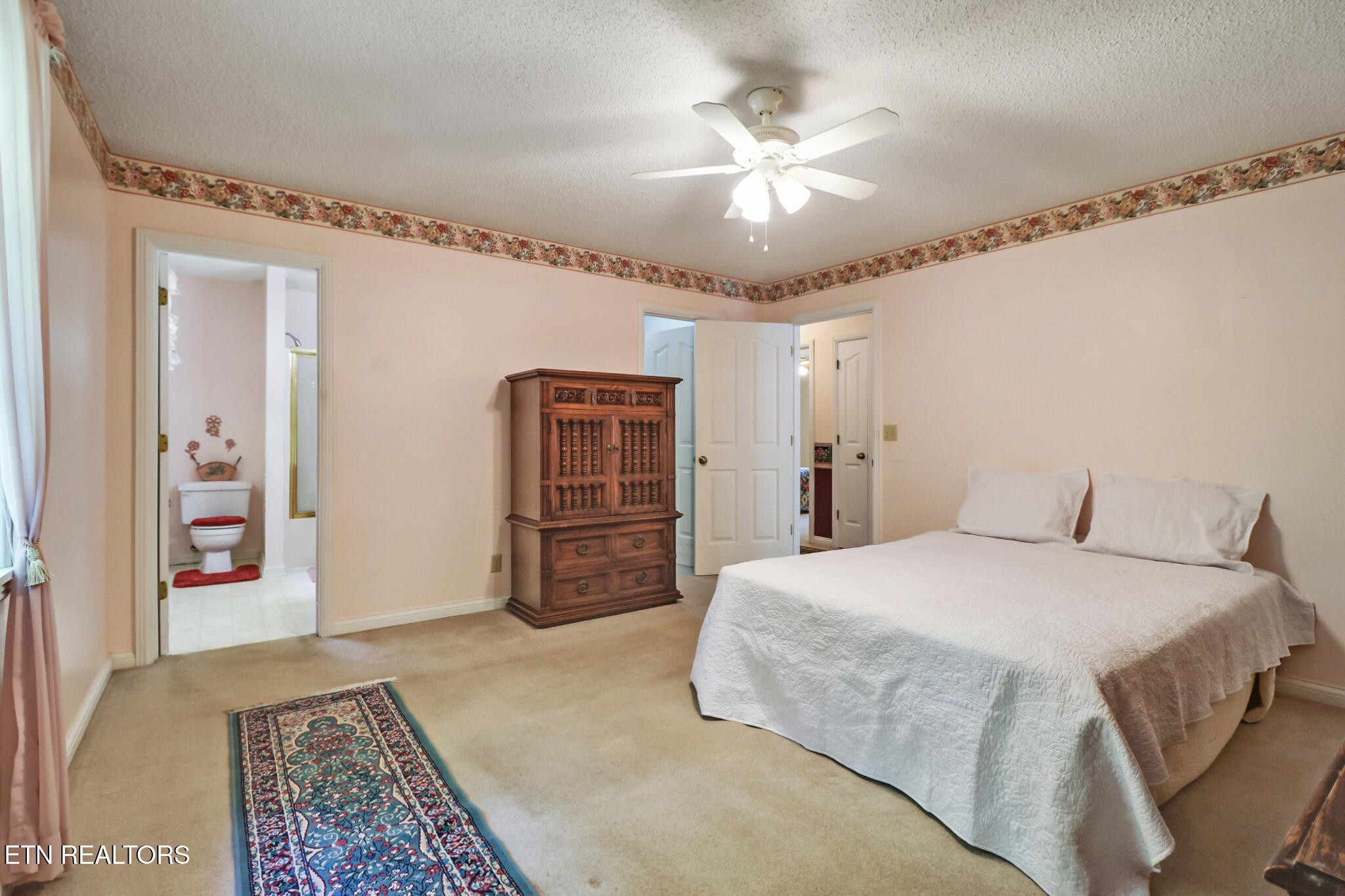 2162 Spruce Loop Crossville, TN 38555 - Photo 18 of 25 a spacious bedroom with a bed and a chandelier
